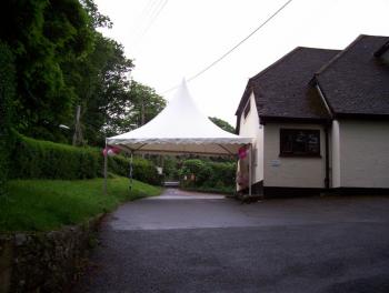 Wedding, showing the use of a hired gazebo to create a lobby for arriving guests.